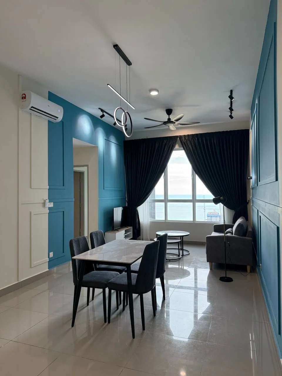 Completed WWC renovation with a blue feature wall, dining area, and living space